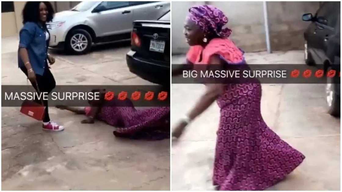 Happy mother rolls on the floor as daughter surprises her