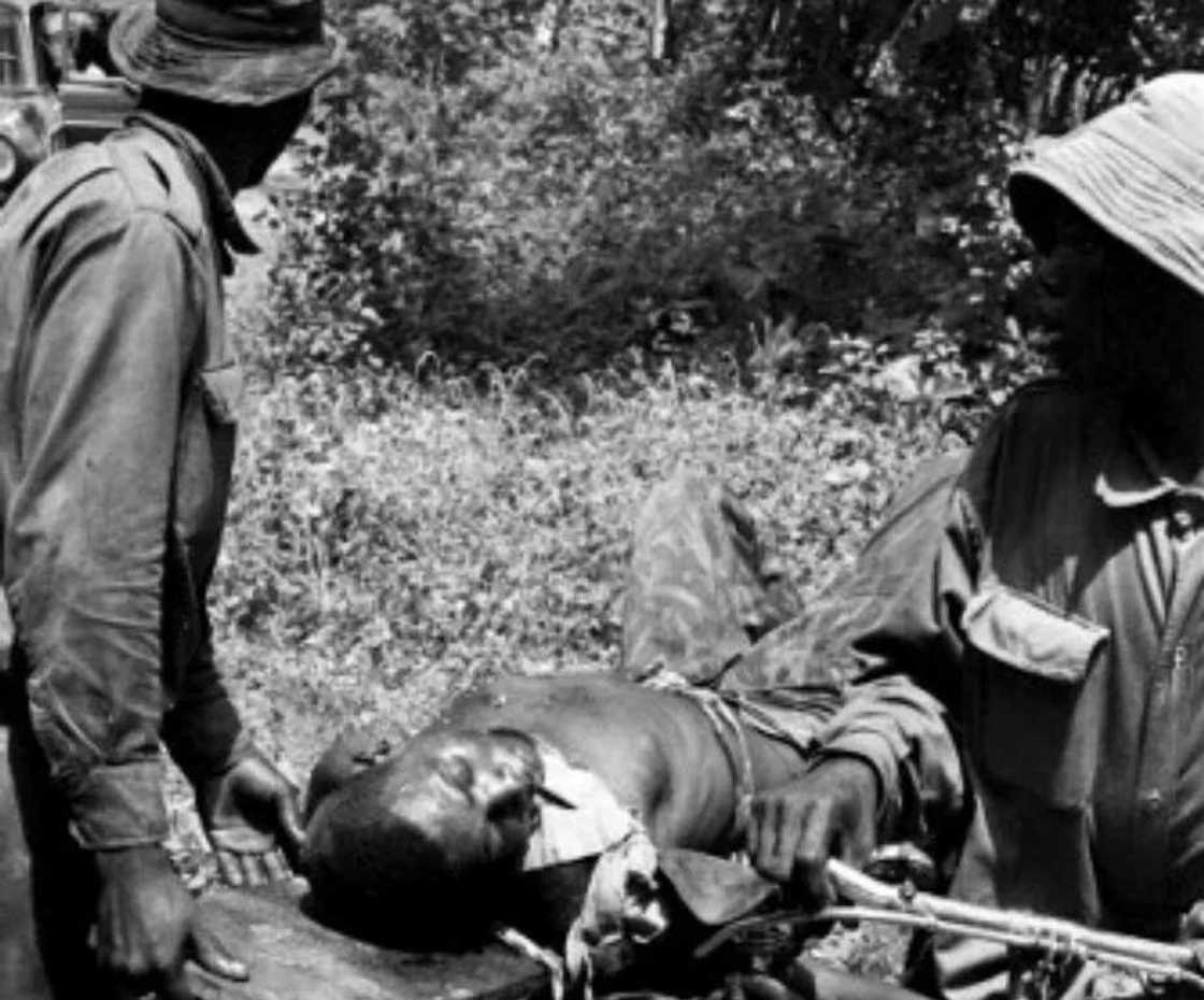 A Nigerian solider wounded in the neck being carried by his comrades