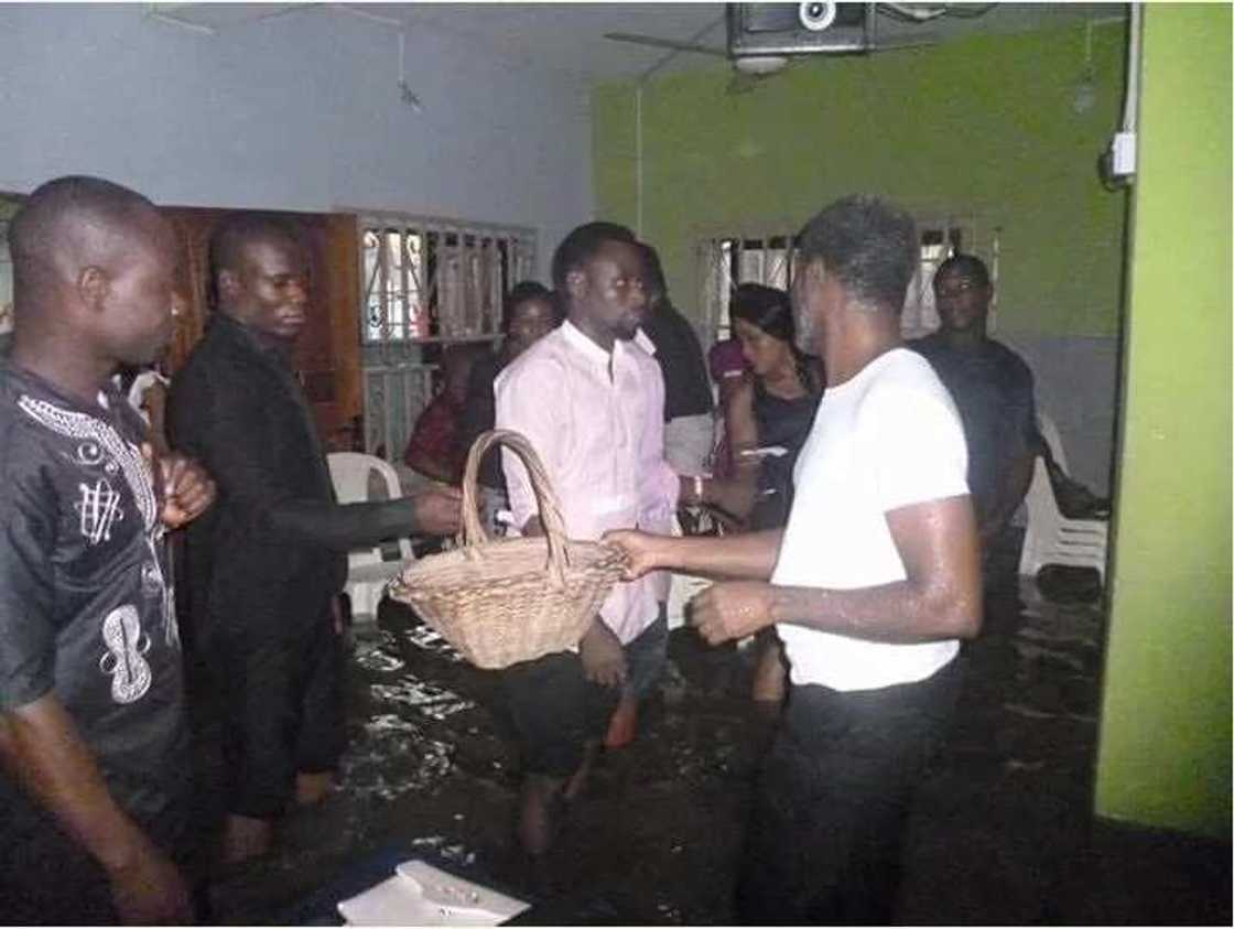 Members of a church worship inside a flooded arena in Port Harcourt