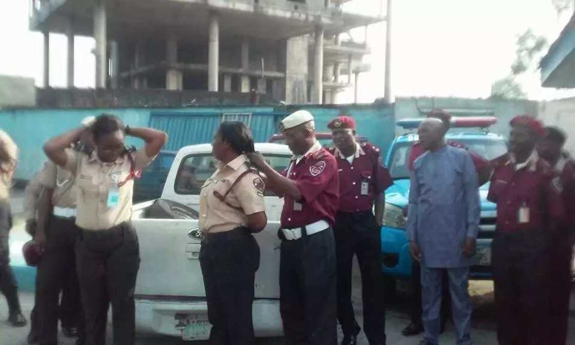 FRSC Sector Commander cutting off female officers' hairs FRSC Sector Commander cutting off female officers' hairs