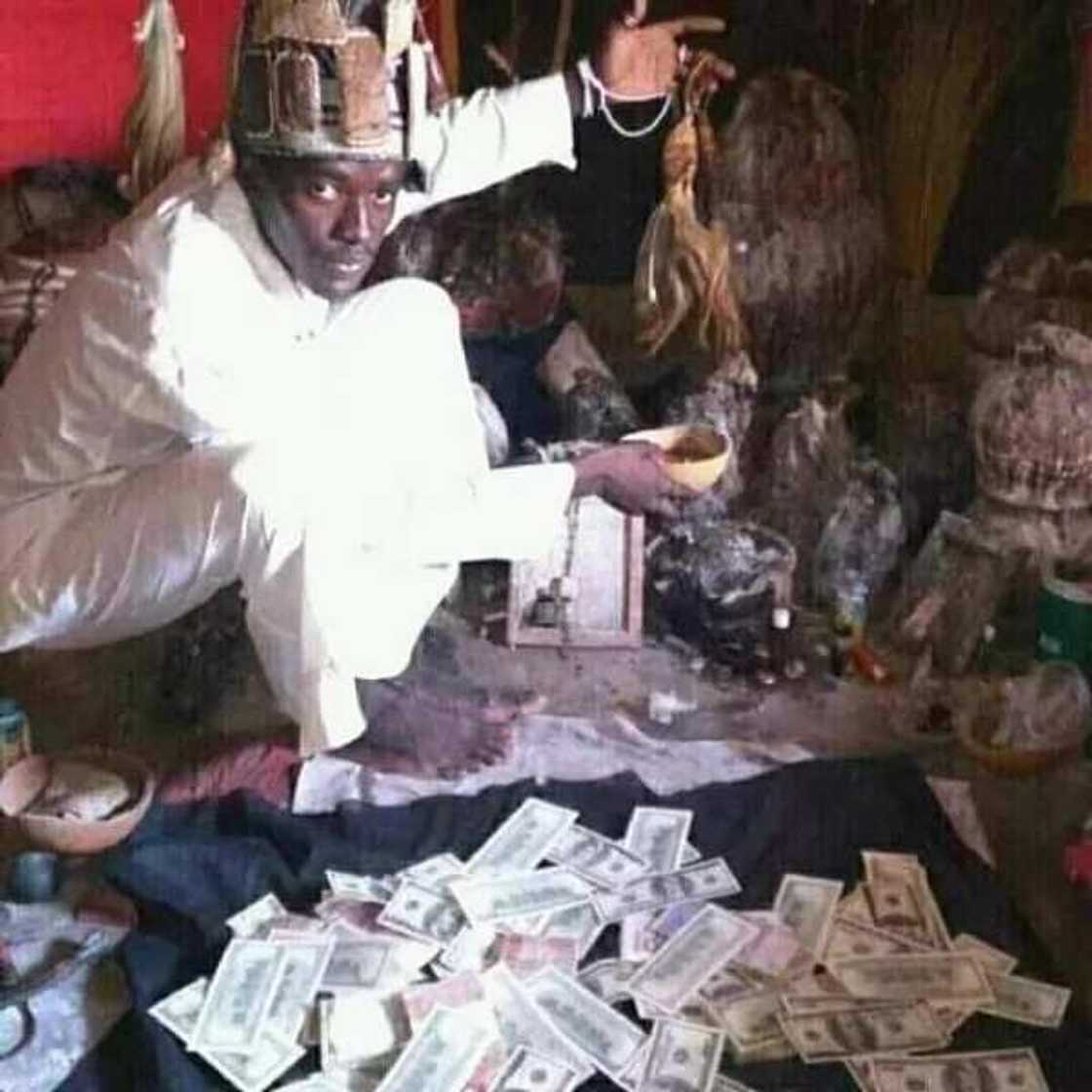 Ogun Native Doctor poses with dollars, claims he can make anyone rich