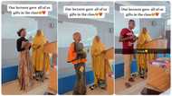 Female lecturer surprises students with gift in class, they walk to the podium excitedly in video