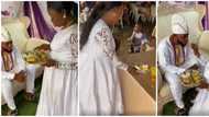 She's not even happy: Nigerians react to viral video of sad pregnant bride kneeling to feed groom at wedding