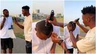 "It won't be funny": Nigerian man shaves stranger's hair in public, he reacts in trending video
