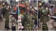 "Nigeria don better": Man in military camo takes to market, preaches gospel passionately in heartwarming video