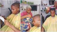 Talented Nigerian female barber gives boy fine haircut with a knife, video sends netizens into a frenzy