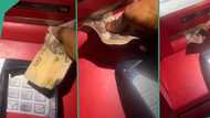 "Call bank security": Man's N1000 note gets stuck in ATM, funny video trends on TikTok