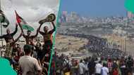 Thousands of Gazans trek back to their ruined city as Israeli troops withdraw