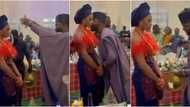 Bride stands like a tree, refuses to smile as hubby sprays her money at wedding, many say it's tradition