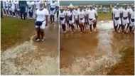 Video of dedicated corps members marching inside dirty water in camp stirs reactions among Nigerians