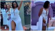 Nigerians react as woman with very high-slit dress struggles to cover herself in trending video