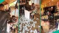 Mixed reactions as Nigerian boys spray cash on mum at her provision shop, video trends online