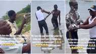 Nigerian man takes boy who doesn't like water to river, bathes him forcefully with soap, people gather around