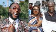 Viral video shows Burna Boy's neighbour telling police to arrest his father for noise-making, claims singer still owes N100m for his house (video)
