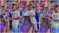 Nigerian man impresses women with his hairdressing skill in video, styles lady's hair into perfect braids
