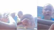 This is unhygienic: Massive reactions as Lady feeds street kids ice cream, shares same spoon with them