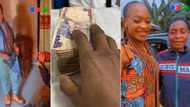 Smart corper saves all her allawee for 12 months, withdraws bundles of cash to buy phones for parents
