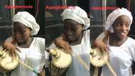 "You too Much": Talented young lady drums in church gown with left hand, stands close to a microphone in Video
