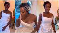 Ebony bride glows in wedding look as she sports curly pixie hairstyle with stunning dress