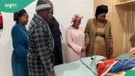 Family members gather around little boy late at night to wish him happy birthday