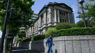 Bank of Japan holds rates, says to slow bond purchase taper