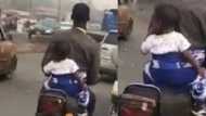 Where is the mother? Hilarious reactions as man is seen backing his baby and riding a motorcycle in video