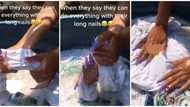 "Buy washing machine": Mixed reactions as lady with long nails struggles to do laundry in video