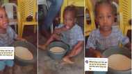 Funny little girl nabbed by mum eating raw garri from bowl denies in video, says she didn't touch it