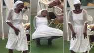 "Is she a robot?" Old woman in white gown and black sandals dances boldly in public, people stare in video
