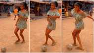"She has great skills": Slim lady plays football stylishly in street as fans gather to watch, video goes viral