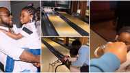 Davido happily 'chops knuckle' with Imade as she knocks down bottles during a bowling game