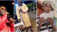 Burna Boy shows love to young singer who held his leg in viral video, gives him N1.7m cash
