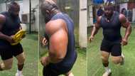 "This job no easy": Kizz Daniel's macho bouncer caught on camera running vigorously at gym