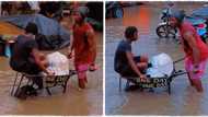 "One day I will make it": Man hustles in flooded area, carries woman in wheelbarrow in viral video