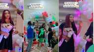 Young man pops the question to his girlfriend as friends rain money on her in a romantic video