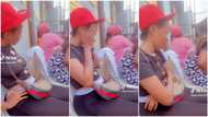 Nigerian lady makes funny faces at baby on mum's back, kid keeps looking in viral video