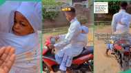 Man who goes to white garment church carries baby to Sunday service on his back while riding a bike