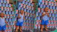 Nigerian mum displays empty cans of milk her little son consumed, video shows toddler clapping hands