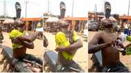 "He can fix Nigeria": Man balances slippers on his forehead for several minutes as he undresses in video
