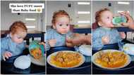 "She loves fufu": Cute baby girl eats swallow like adult, viral video shows her enjoy big lump