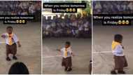 Little school boy in big shorts gives cool moves, dances like a girl in front of students and adults in video