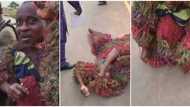 Masquerade unmasks, shows real face as he rolls on the floor begging for money in Owerri, video causes stir