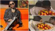 Kizz Daniel finds Zambian flower lady he shunned at airport, hugs her and collects new bouquet in video