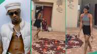 Lady spreads wrapper on bare floor, puts Wizkid's photo on it and sleeps beside it on his birthday