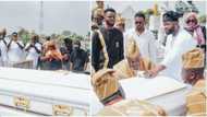 Emotional photos as singer Skales buries late mum, spotted giving her last look, pouring sand on casket