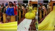She doesn't have friends: Reactions as bride enters wedding venue rocking weird long yellow dress in video