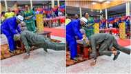 Rare pictures of APC governor lying flat on the floor spark reactions