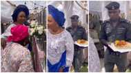 Why is he frowning? Reactions trail video of Nigerian policeman carrying served food for 'big woman' at event
