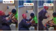 Viral video shows pretty Nigerian lady expressing love for 'aboki' fixing her footwear, almost kisses him