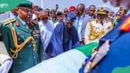 Iconic photo, video show Tinubu standing beside Buhari’s body, Nigerians react